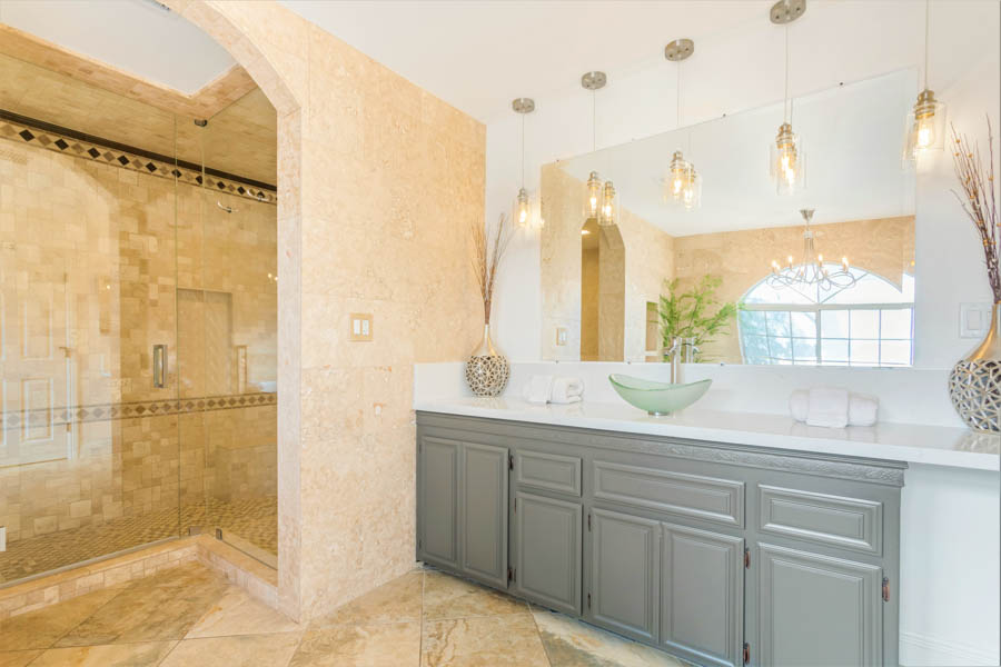 luxury bathroom with built in cabinets, soaking tub, shower